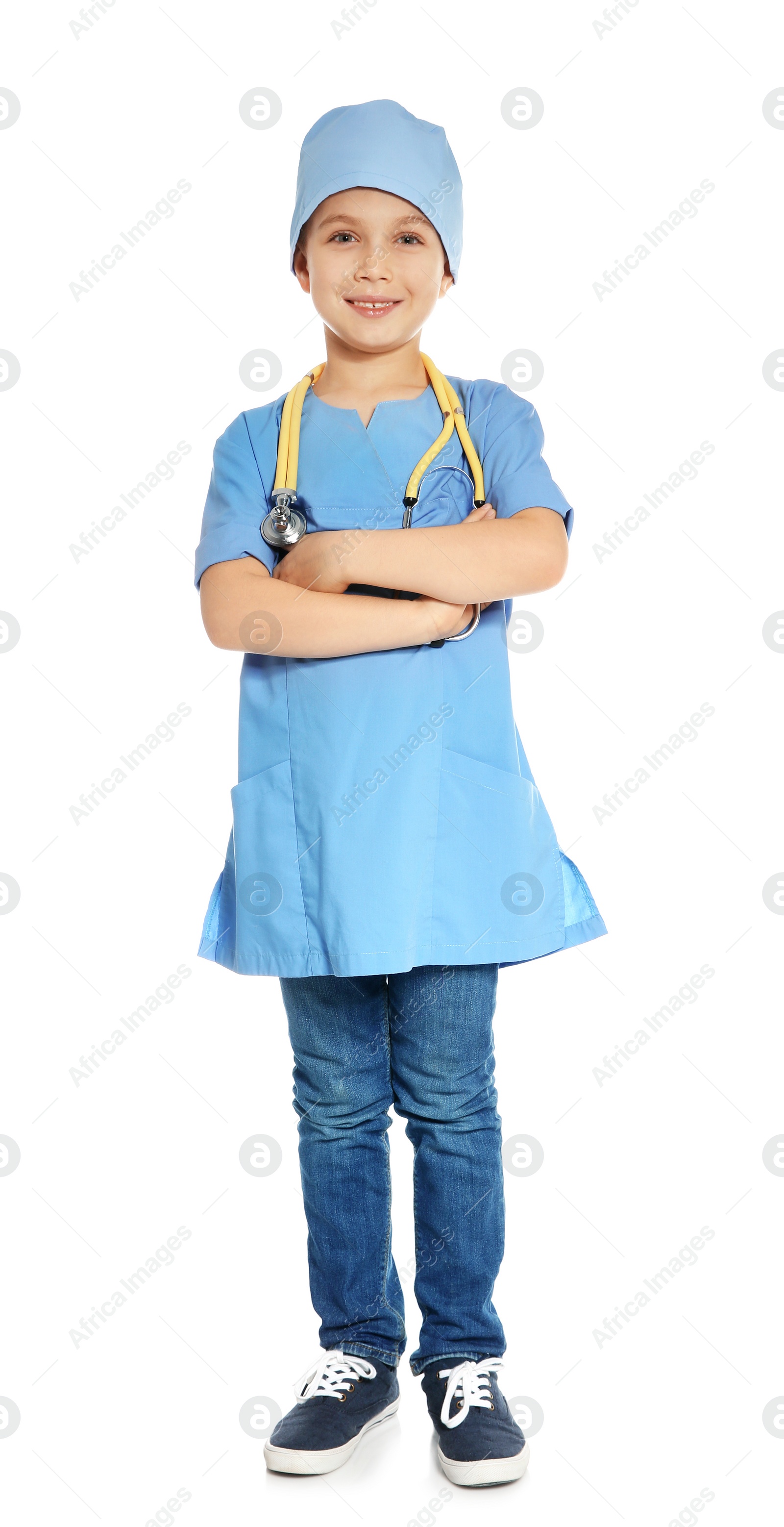 Photo of Cute little child in doctor uniform with stethoscope on white background