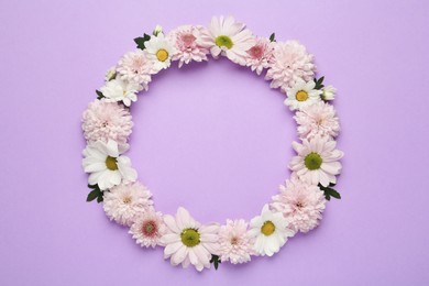 Photo of Frame made of beautiful chrysanthemum flowers on violet background, flat lay. Space for text