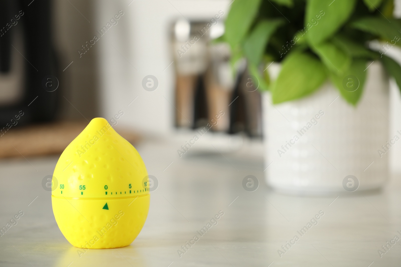 Photo of Kitchen timer in shape of lemon on white table indoors. Space for text