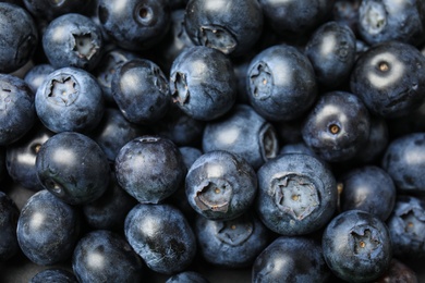 Fresh tasty ripe blueberries as background, closeup