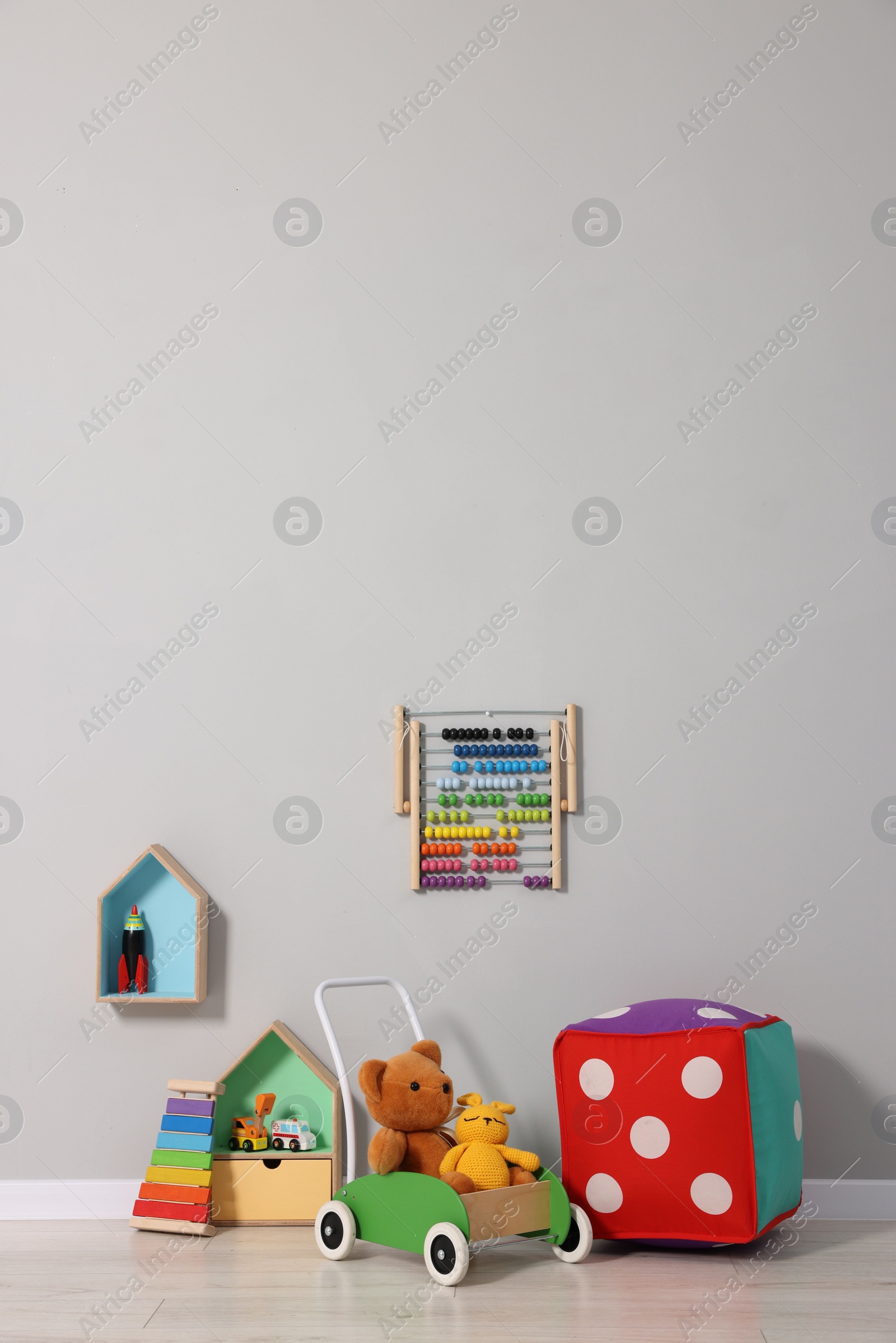 Photo of Beautiful children's room with grey wall and toys. Interior design