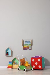 Photo of Beautiful children's room with grey wall and toys. Interior design