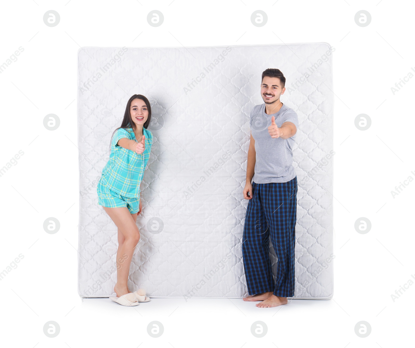 Photo of Young couple with comfortable mattress isolated on white