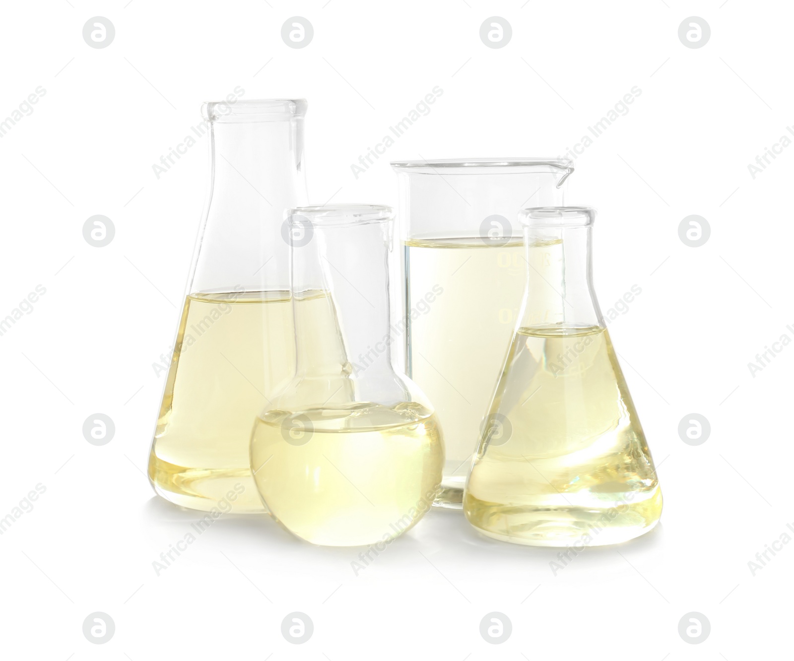 Photo of Laboratory glassware with liquid on white background. Chemical analysis