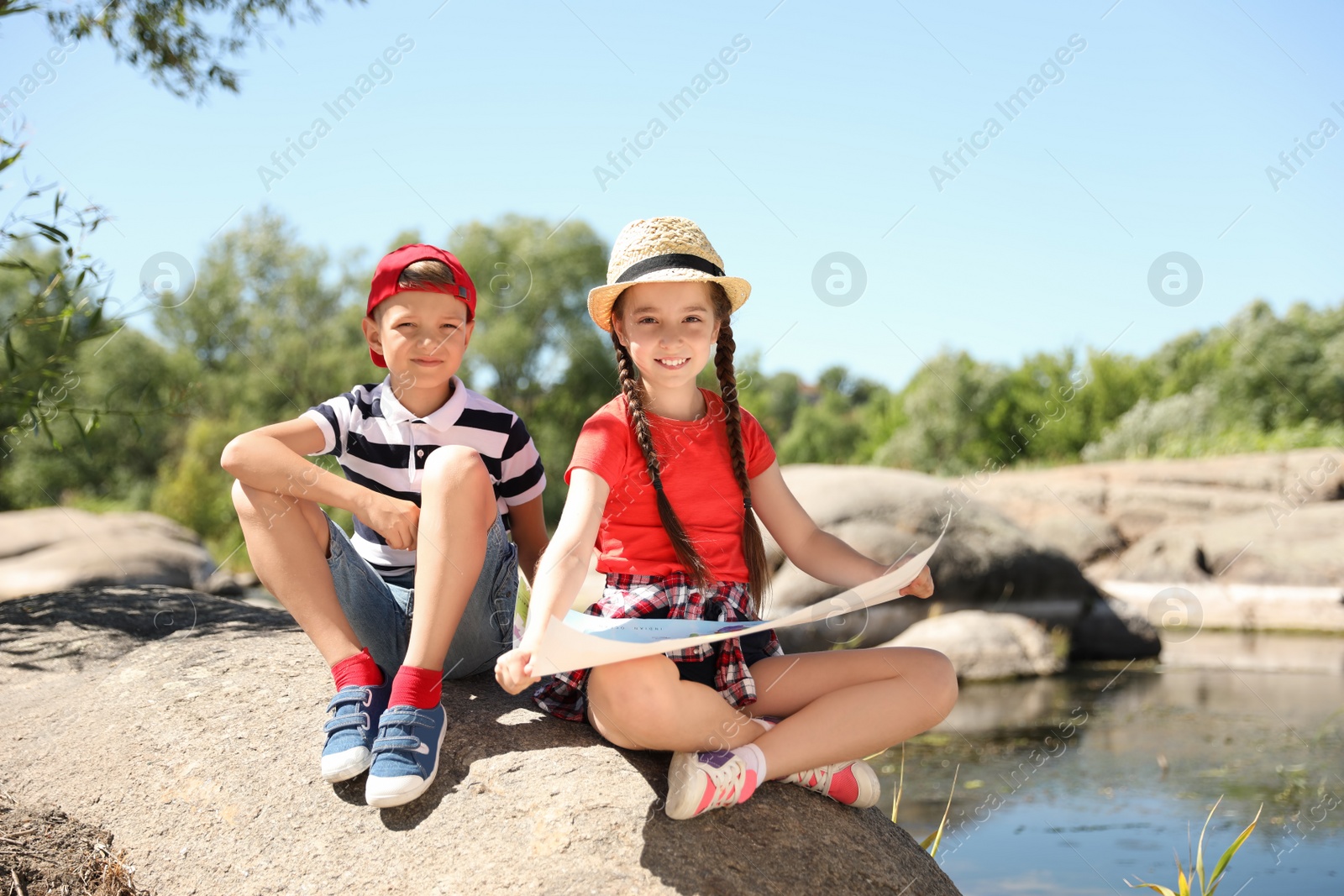 Photo of Little children with map outdoors. Summer camp