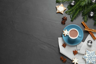Delicious hot chocolate, cookies and Christmas decor on black table, flat lay. Space for text