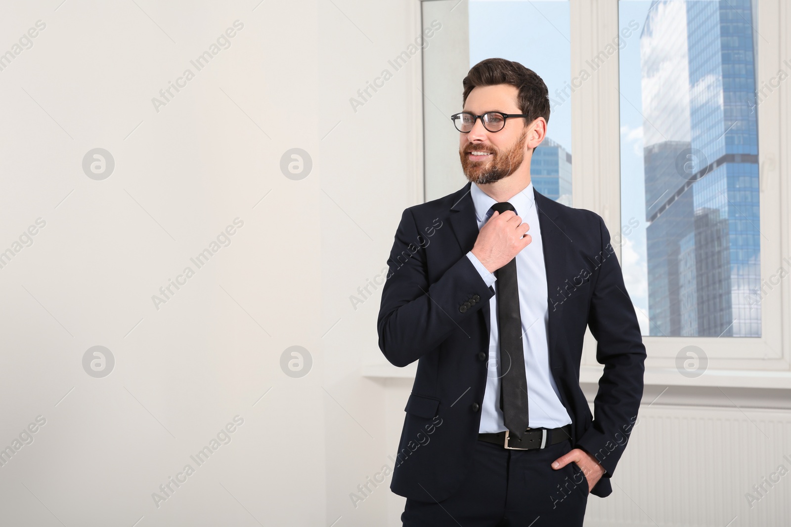 Photo of Handsome real estate agent in nice suit indoors, space for text