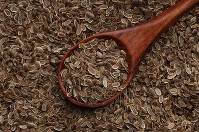 Photo of Dry dill seeds and wooden spoon, top view
