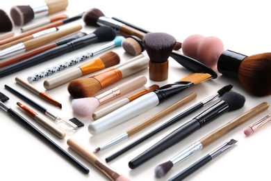 Makeup brushes of professional artist on white background