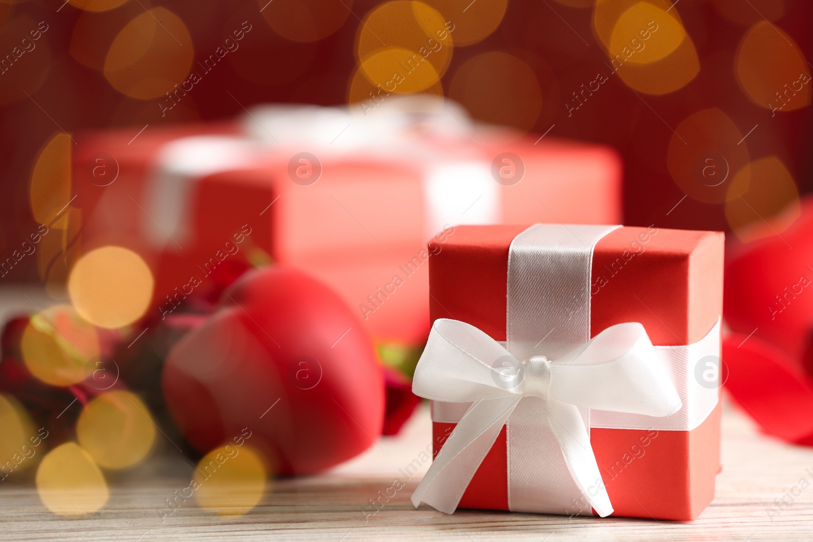 Photo of Gift box on light wooden table, space for text. Valentine's Day celebration