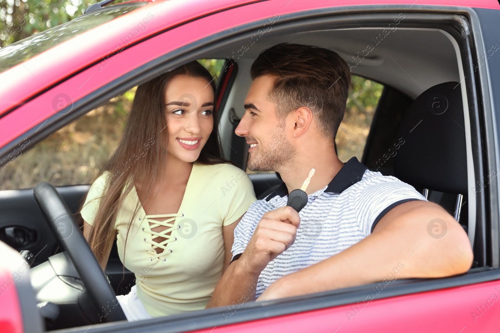 Photo of Happy young couple in new car on road trip