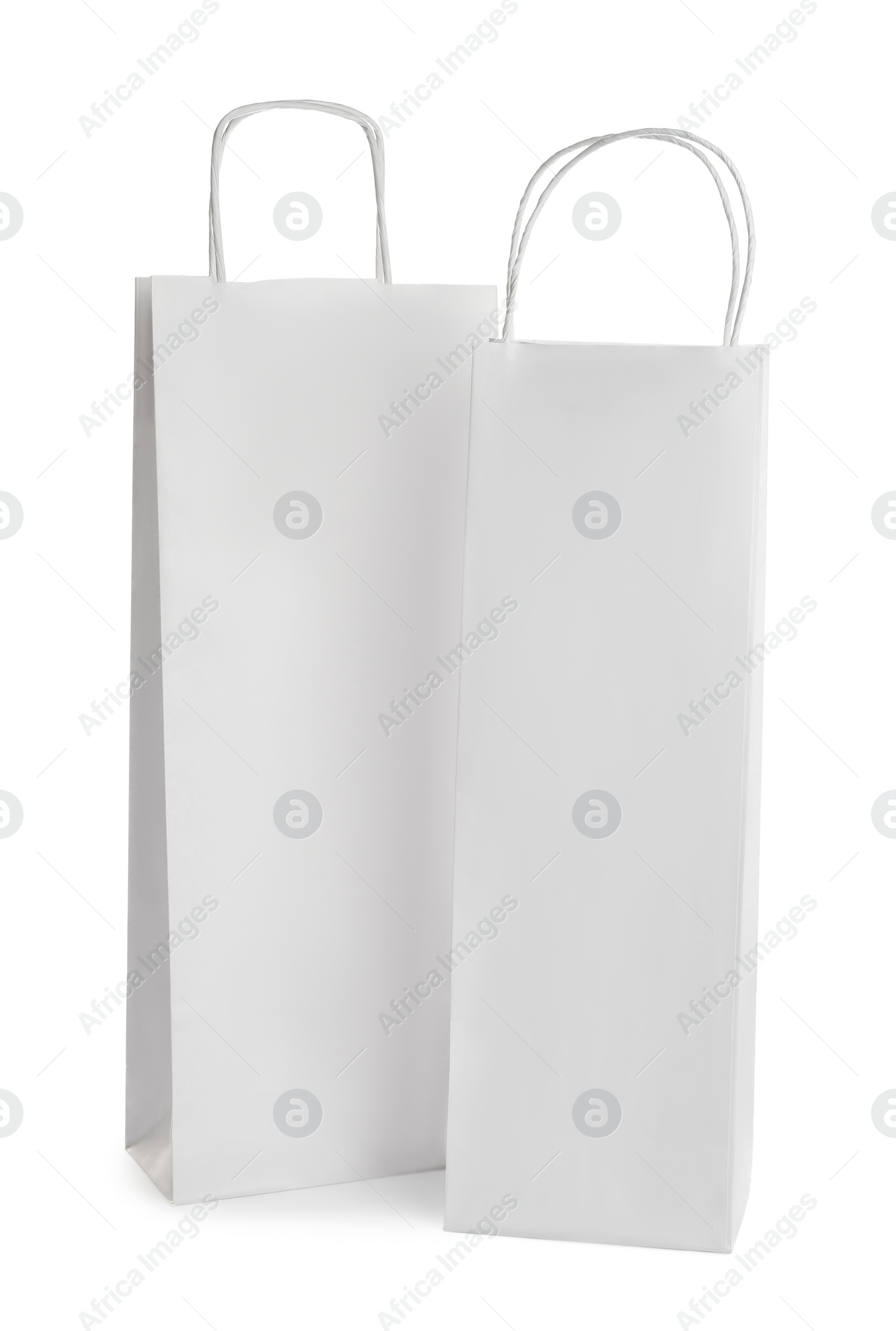 Photo of Blank paper bags on white background. Mockup for design