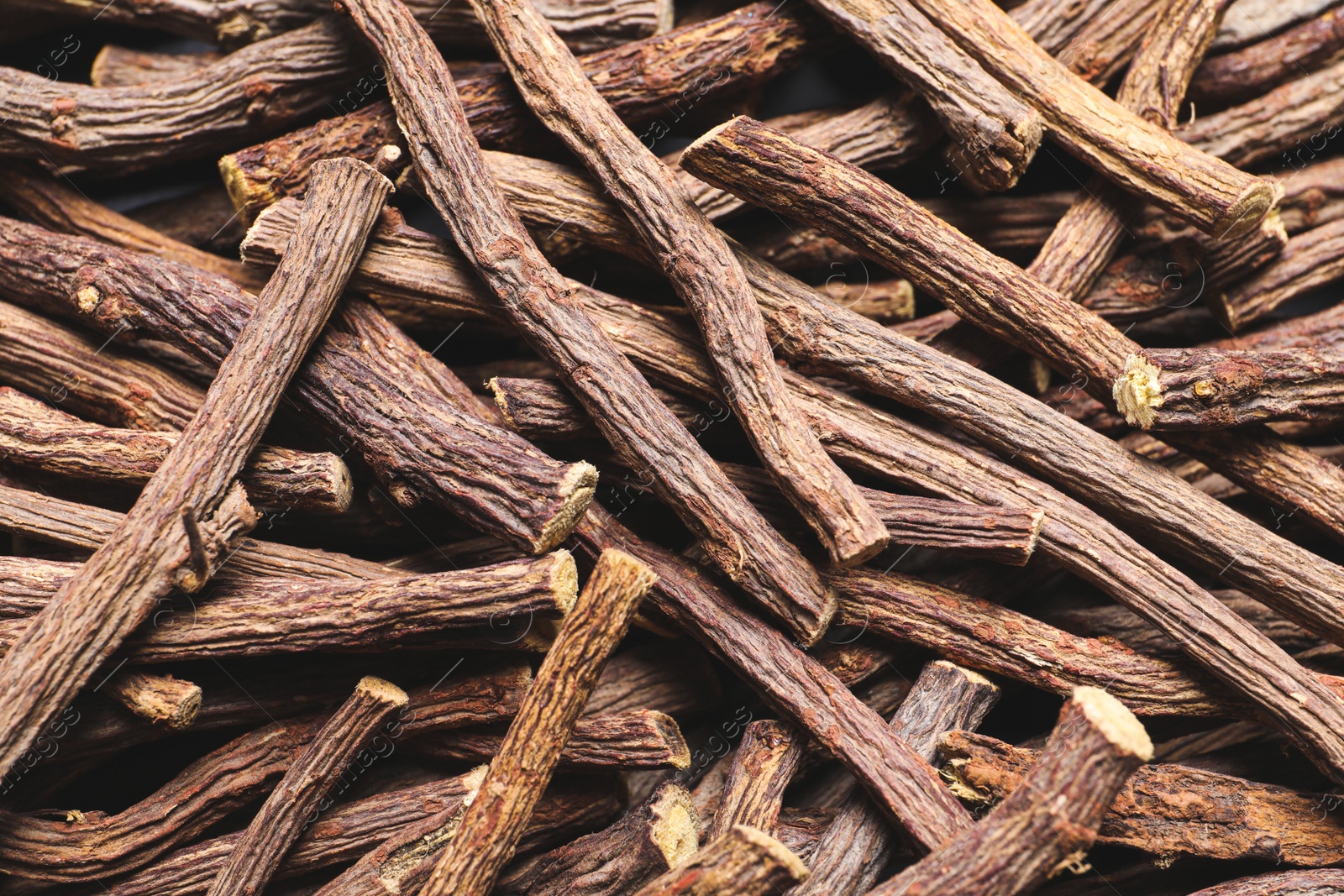 Photo of Dried sticks of liquorice root as background, top view