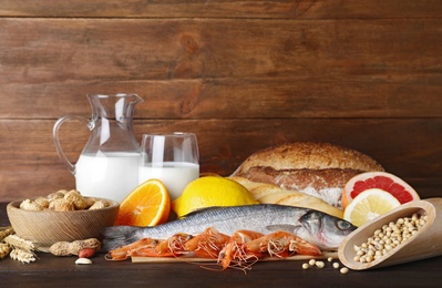 Different products on wooden table. Food allergy concept