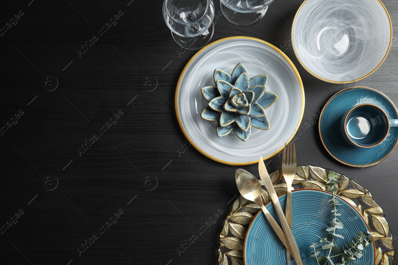 Photo of Elegant table setting and space for text on dark background, top view