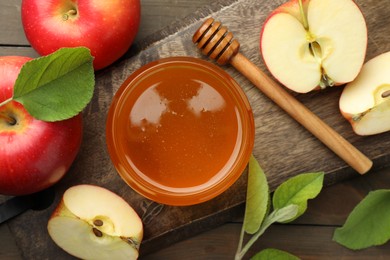 Photo of Sweet honey and fresh apples on wooden table, flat lay