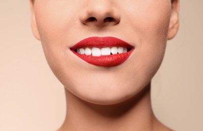 Photo of Beautiful young woman with red lips on color background, closeup