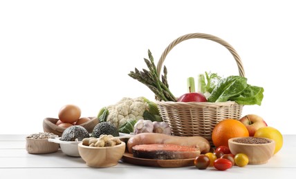 Photo of Healthy food. Basket with different fresh products on wooden table against white background