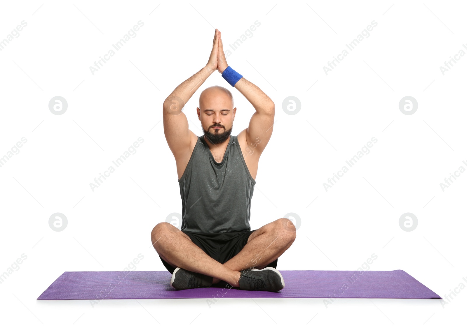 Photo of Overweight man practicing yoga on white background