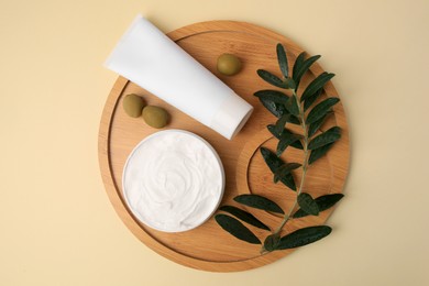 Photo of Natural cosmetic. Different olive creams and ingredient on beige background, top view
