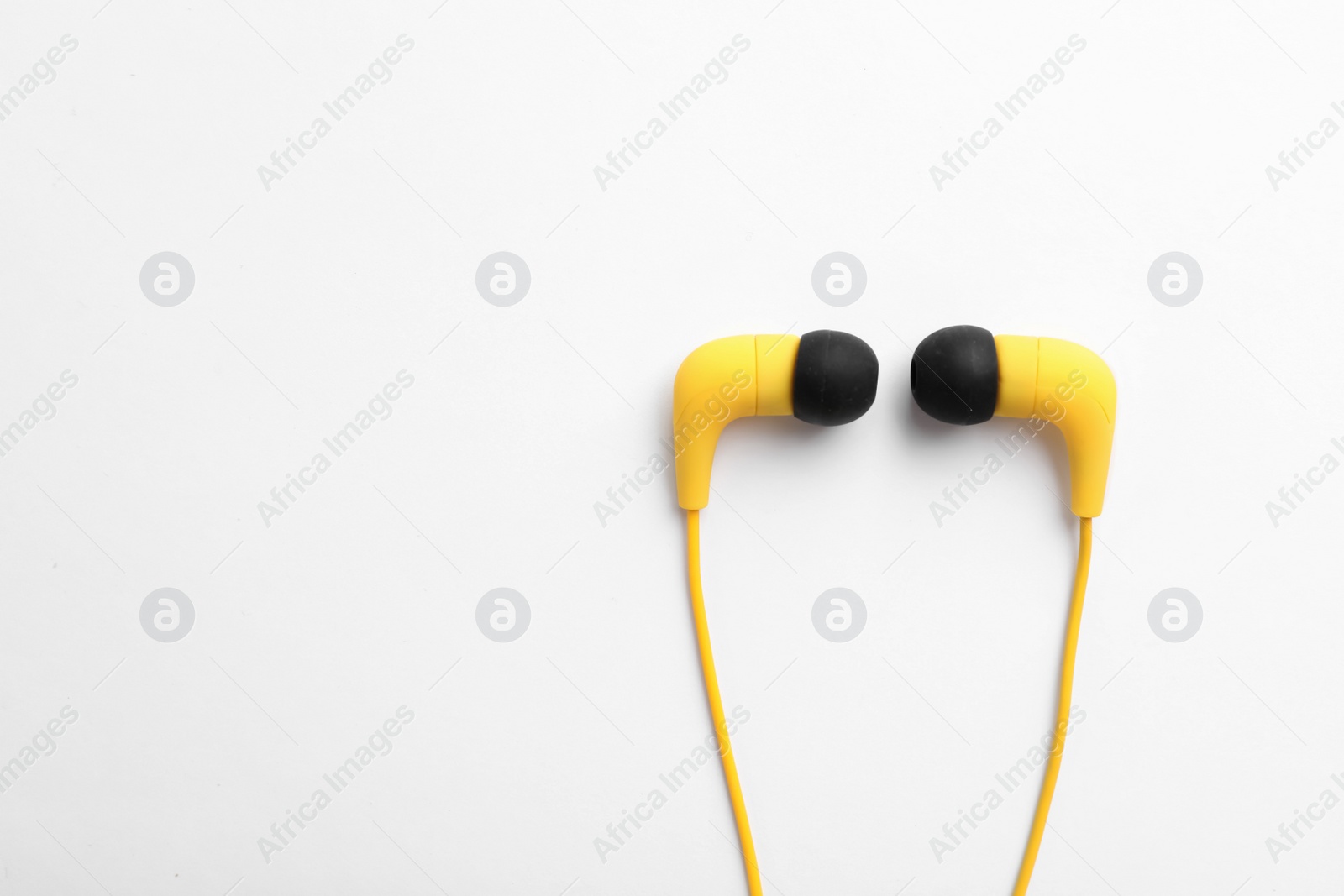 Photo of Stylish modern headphones isolated on white, top view. Space for text