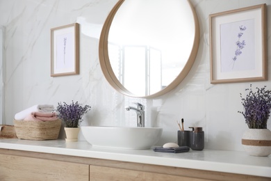 Photo of Mirror and counter with vessel sink in bathroom interior. Idea for design