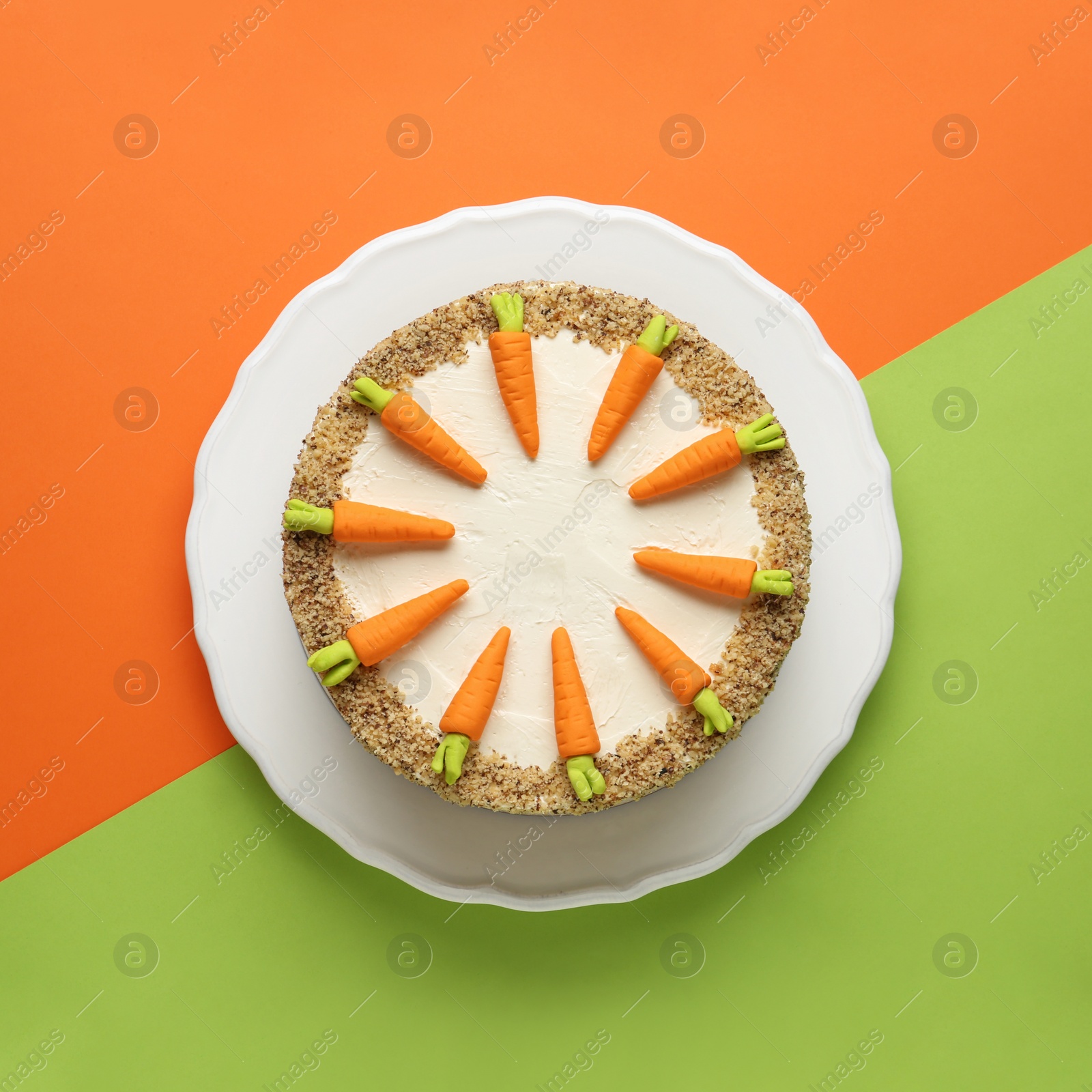 Photo of Dish with tasty carrot cake on color background, top view