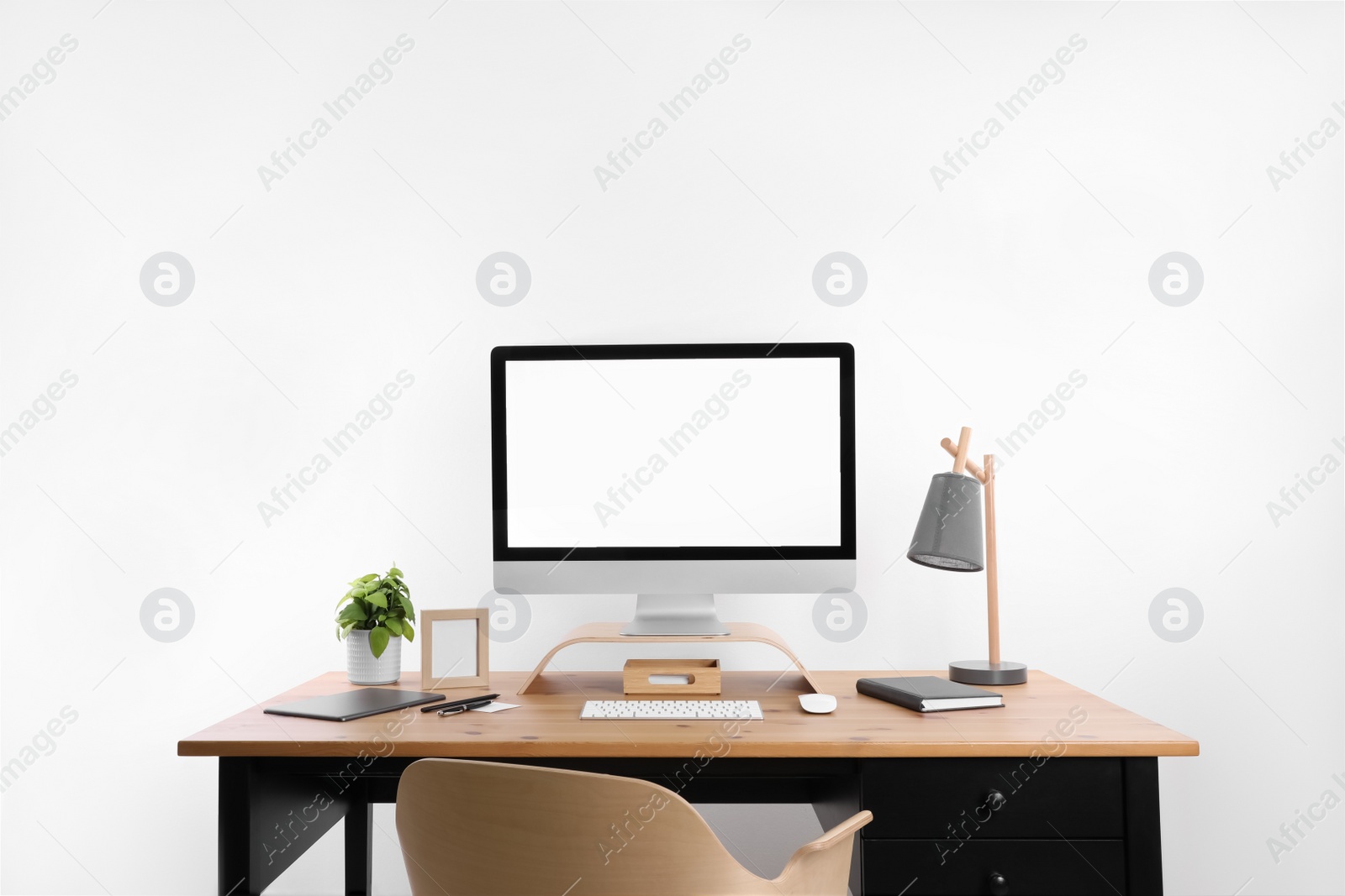 Photo of Modern computer with blank screen on desk, space for design. Comfortable workplace