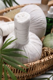 Photo of Spa composition with herbal massage bags and cosmetic products on white table