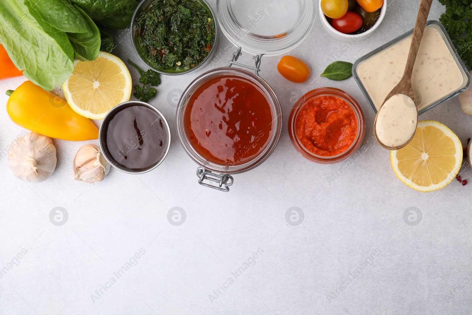 Photo of Different marinades and products on light table, flat lay. Space for text