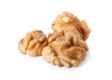 Photo of Heap of tasty walnuts on white background