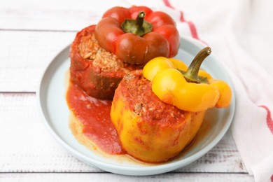 Photo of Delicious stuffed bell peppers on white wooden table, closeup