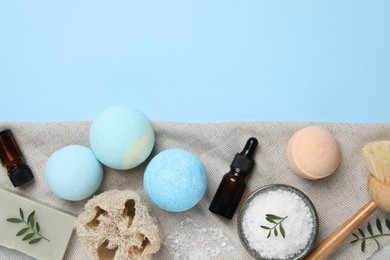 Photo of Flat lay composition with bath bombs on light blue background. Space for text