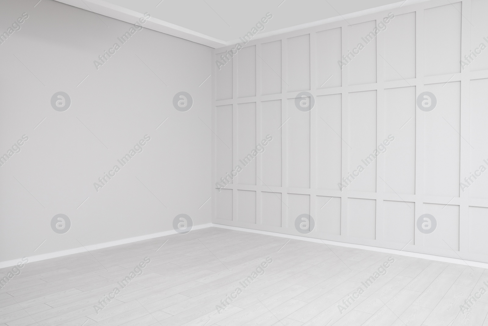 Photo of Empty room interior with white walls and floor