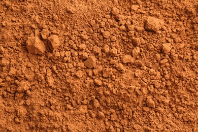 Photo of Cocoa powder as background, closeup