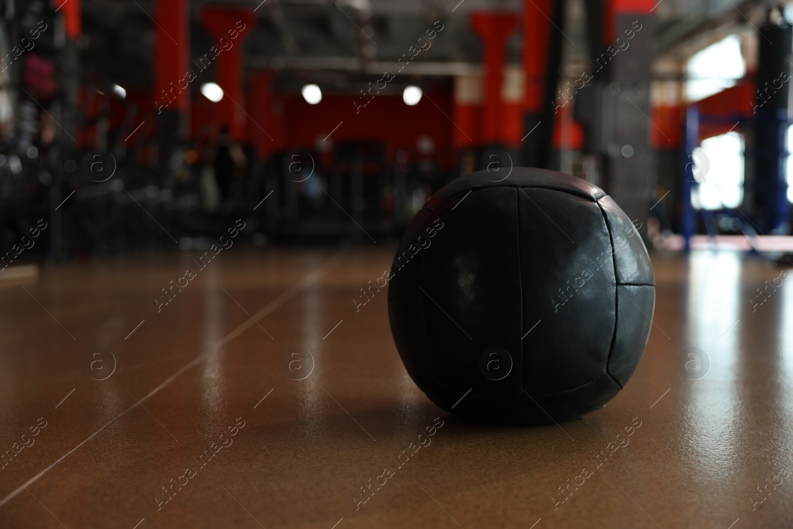 Photo of Medicine ball on floor in gym. Space for text