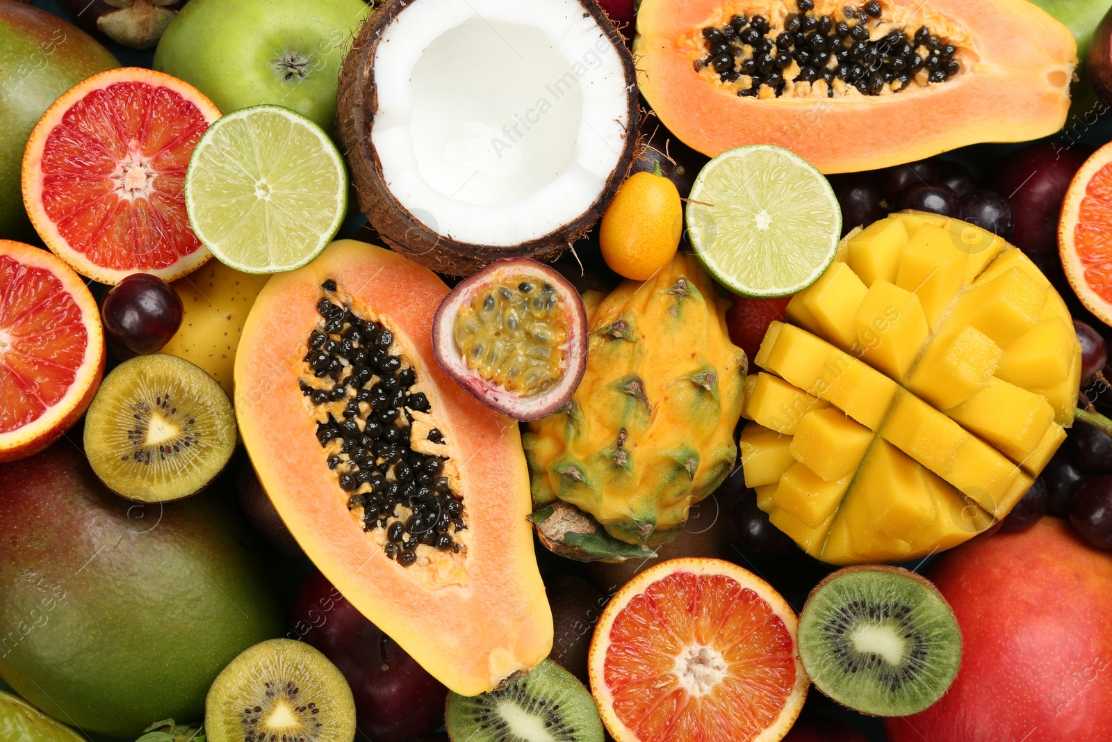 Photo of Many different delicious exotic fruits as background, top view