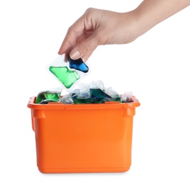 Woman taking laundry capsule out of box against white background, closeup