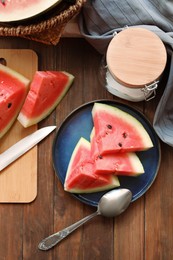 Photo of Sliced fresh juicy watermelon on wooden table, flat lay