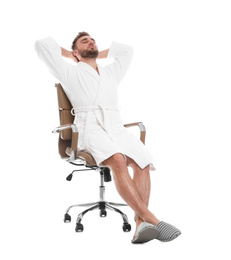 Photo of Handsome man wearing bathrobe resting in chair on white background