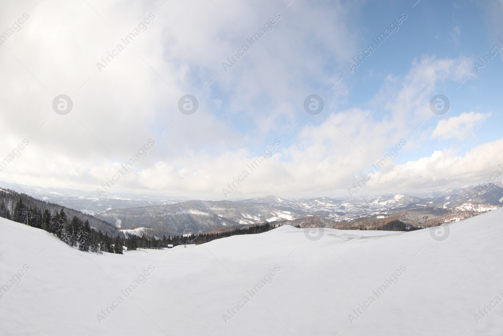 Photo of Picturesque mountain landscape with snowy hills under cloudy sky