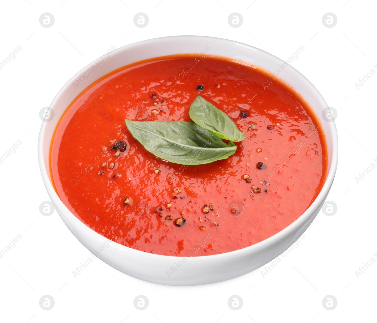 Photo of Delicious tomato cream soup in bowl isolated on white