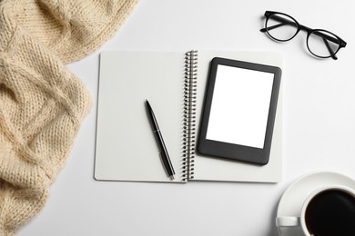 Flat lay composition with modern e-book reader on white table