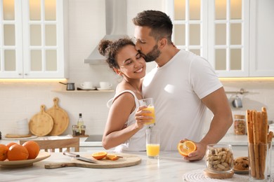 Photo of Lovely couple enjoying time together during breakfast at table in kitchen