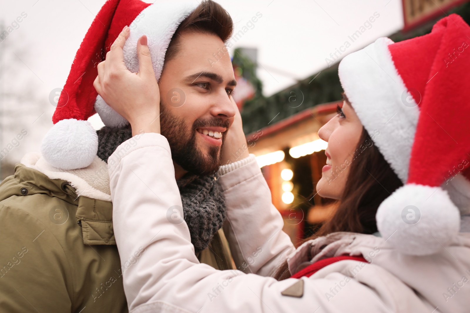 Photo of Lovely couple spending time together at Christmas fair