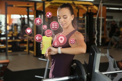Athletic woman with protein shake checking fitness tracker after training in gym