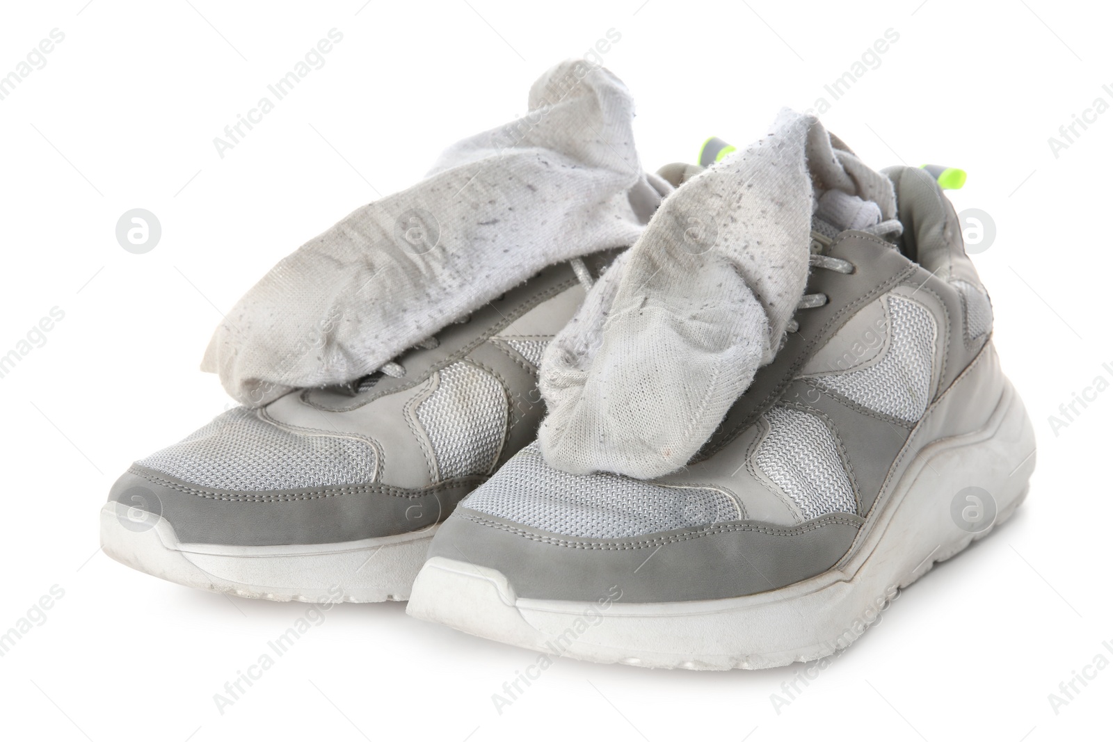 Photo of Sneakers with dirty socks on white background