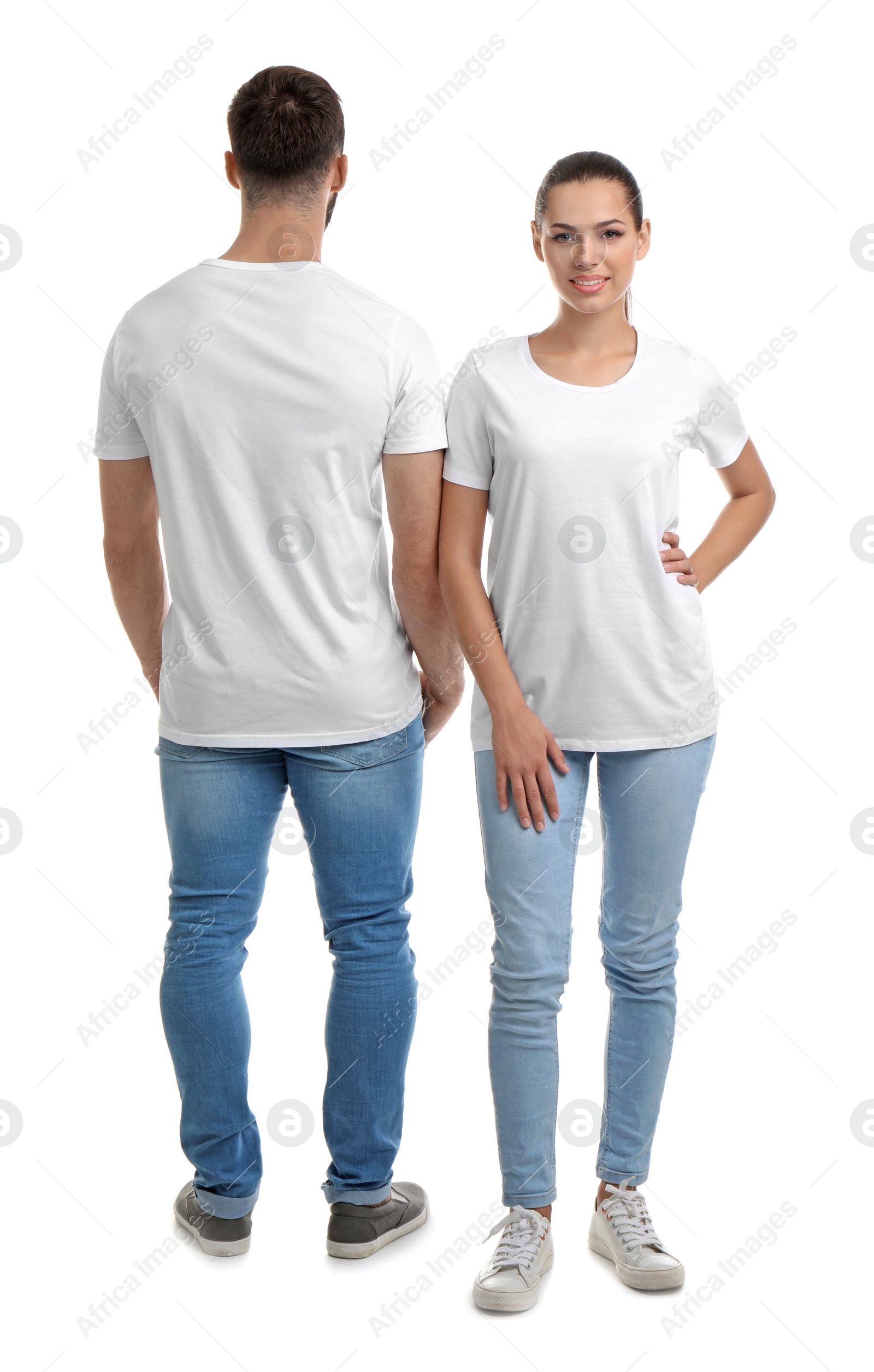 Photo of Young couple in t-shirts on white background. Mockup for design