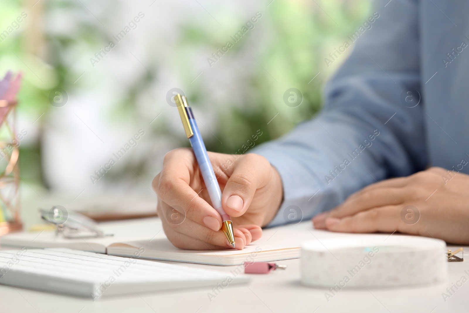 Photo of Journalist working at table in office, closeup