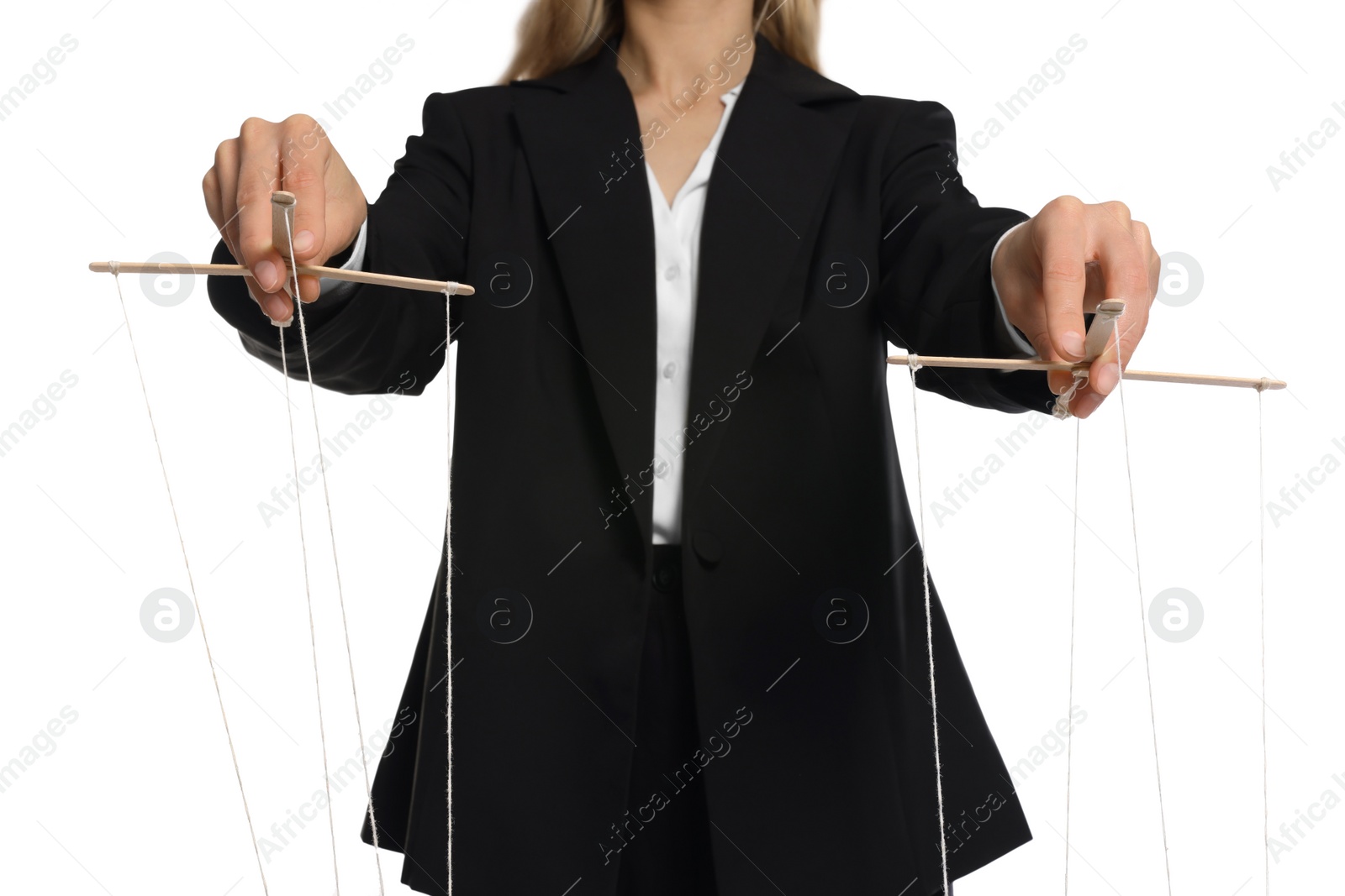 Photo of Woman in suit pulling strings of puppet on white background, closeup